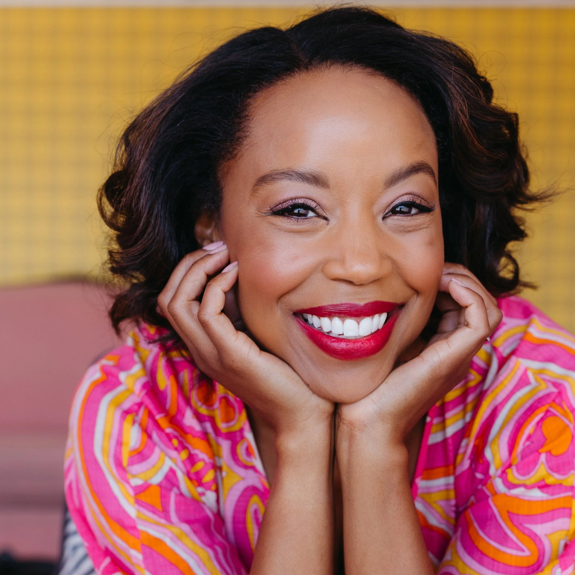 Hilary Ward, smiling, chin resting on her hands
